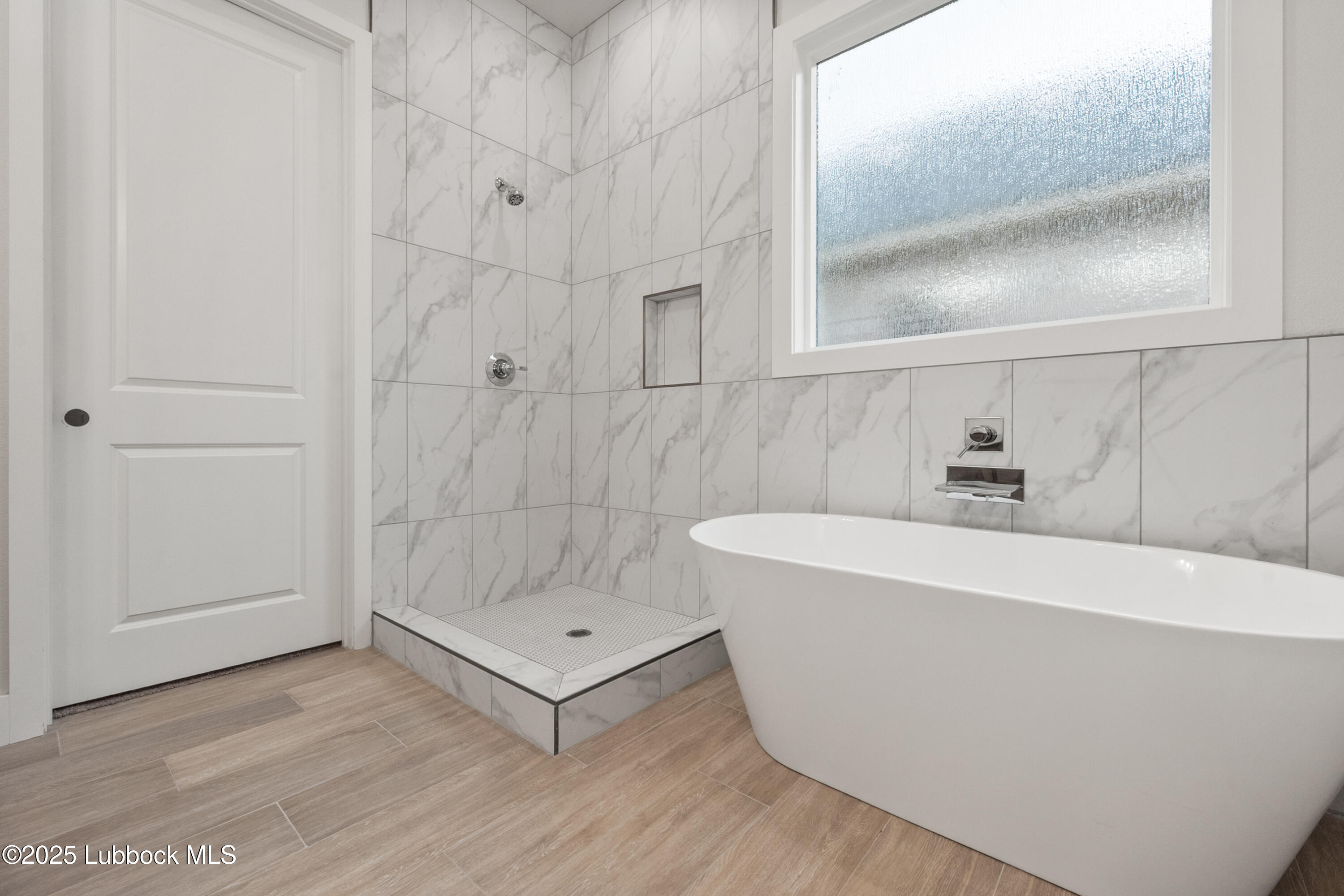 7526 57th Street Lubbock, TX 79407 - Photo 26 of 36 a bathroom with a bathtub and shower