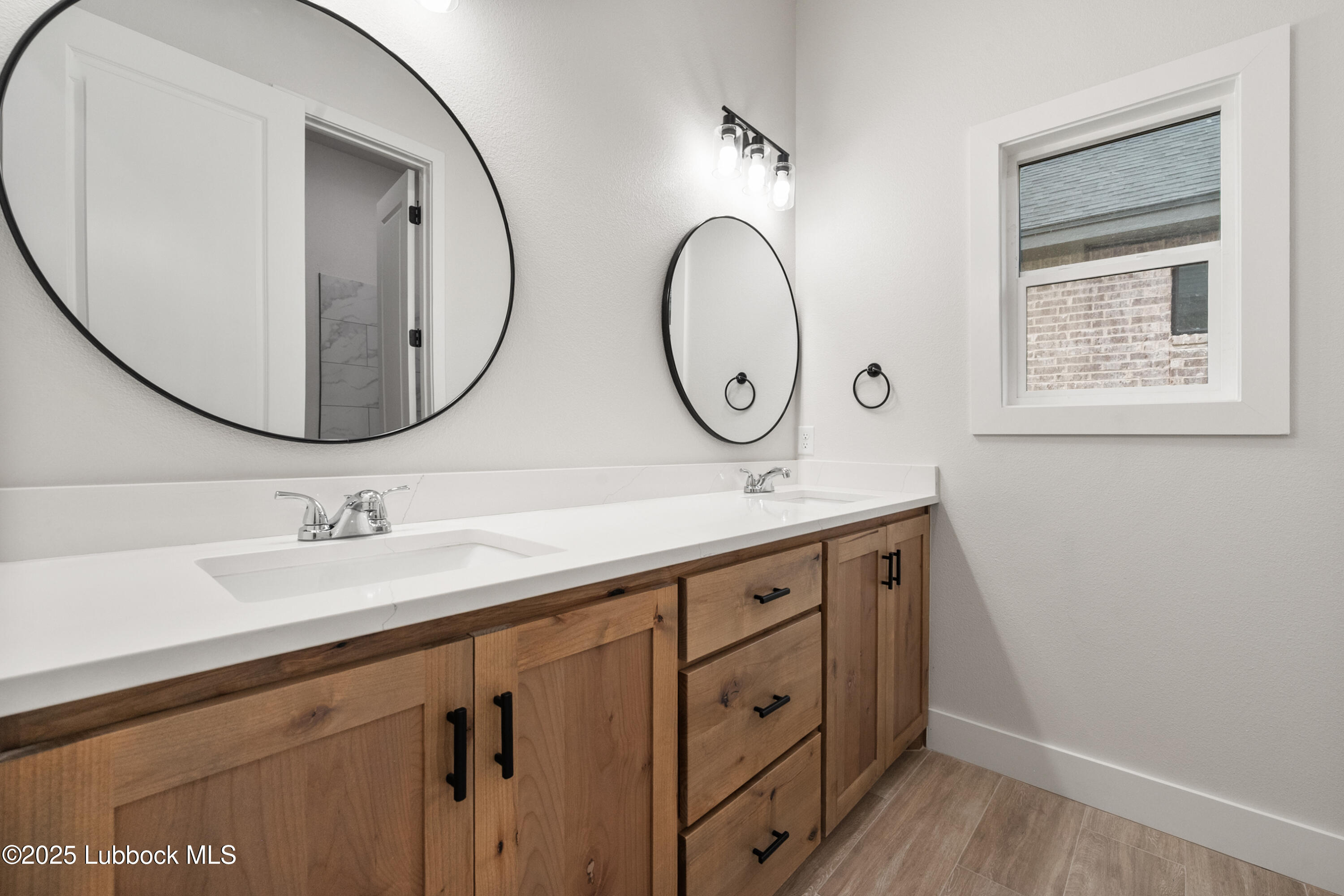 7526 57th Street Lubbock, TX 79407 - Photo 30 of 36 a bathroom with a sink and a mirror
