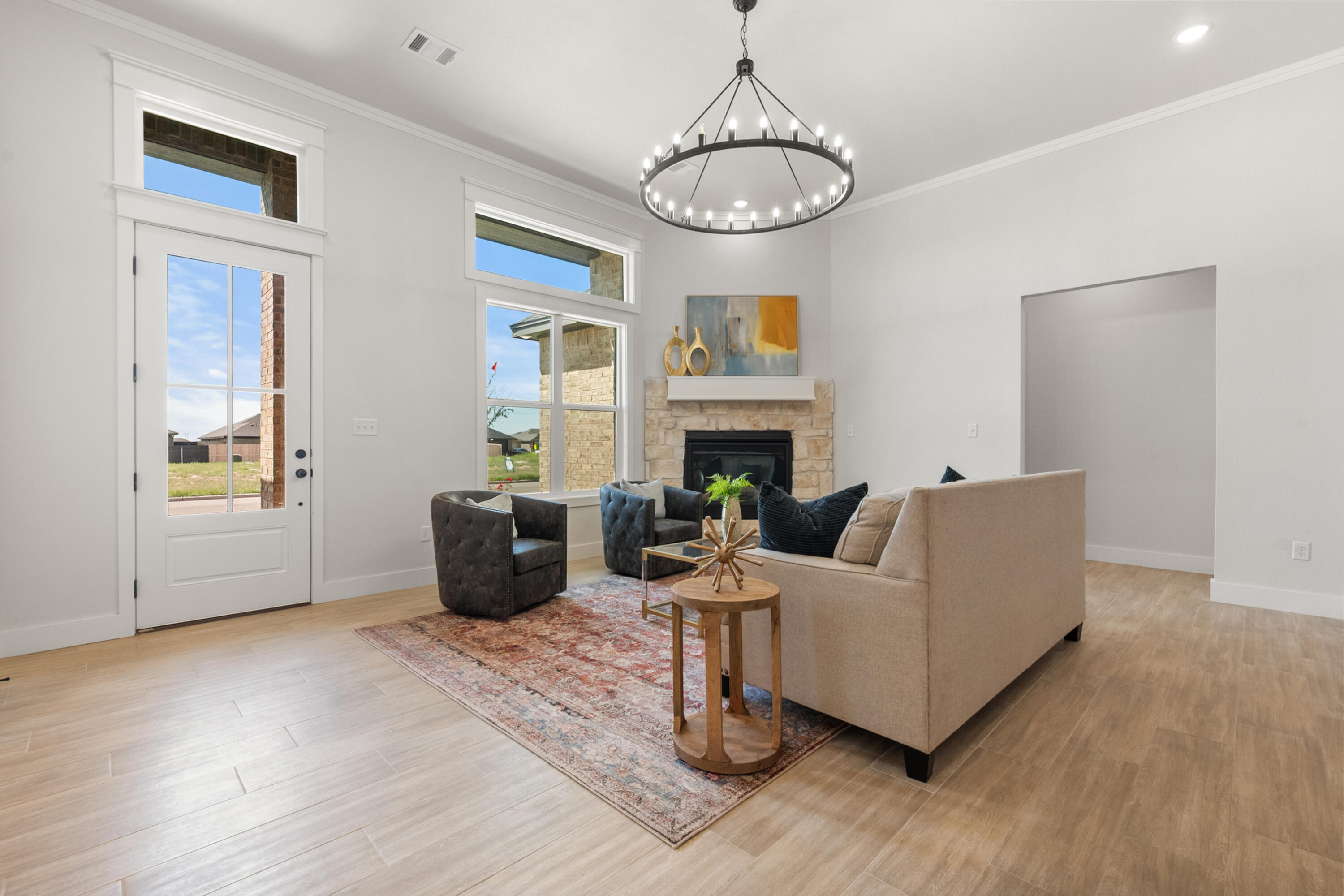 7526 57th Street Lubbock, TX 79407 - Photo 4 of 36 a living room with furniture chandelier and a fireplace