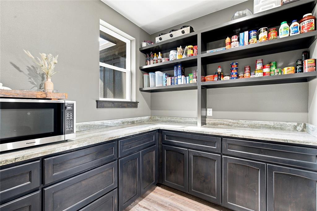 WALK THROUGH PANTRY WITH AMPLE SMALL STORAGE AND COFFEE BAR
