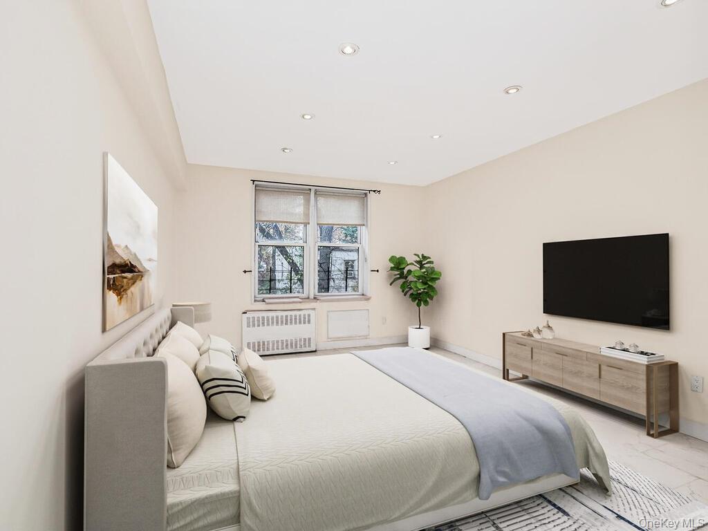 6535 Broadway, Unit 2E Bronx, NY 10471 - Photo 3 of 11 a bedroom with a bed and a flat screen tv