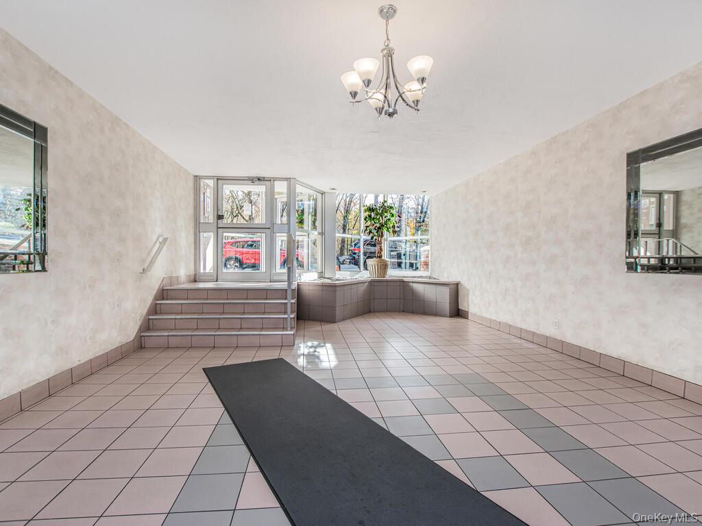 6535 Broadway, Unit 2E Bronx, NY 10471 - Photo 8 of 11 a living room with furniture and a chandelier
