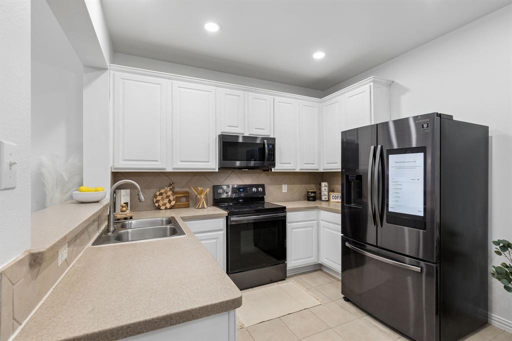 2916 Durango Place Bedford, TX 76021 - Photo 7 of 30 Such an inviting kitchen with black stainless Samsung appliances - Family Hub refrigerator is part of the package