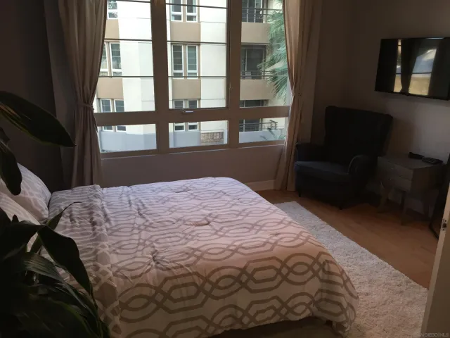 a bedroom with a bed and a window