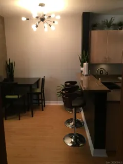 a room with a table chairs and appliances