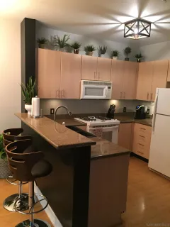 a kitchen with a stove a sink and a refrigerator