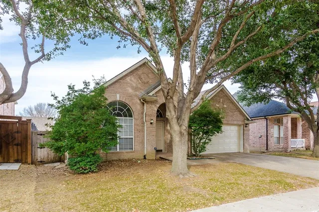 a view of a house with a tree in the background