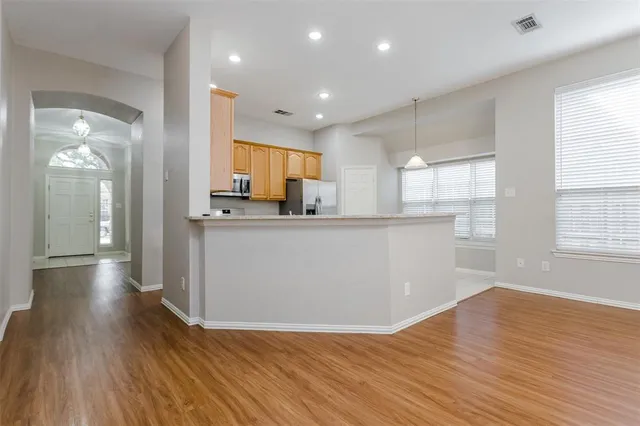 a view of a kitchen with cabinets and wooden floor