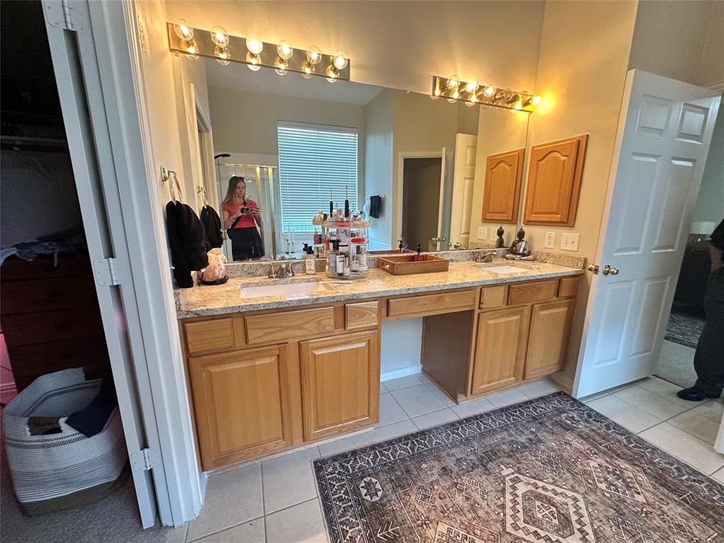 2450 Streamside Court Frisco, TX 75036 - Photo 17 of 28 a bathroom with a sink a toilet and a mirror