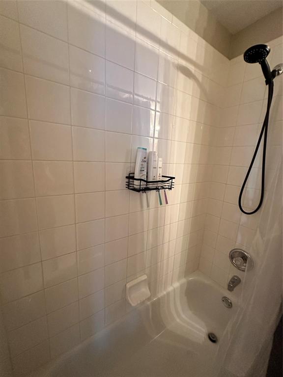 2450 Streamside Court Frisco, TX 75036 - Photo 21 of 28 a bathroom with a bath tub with a shower