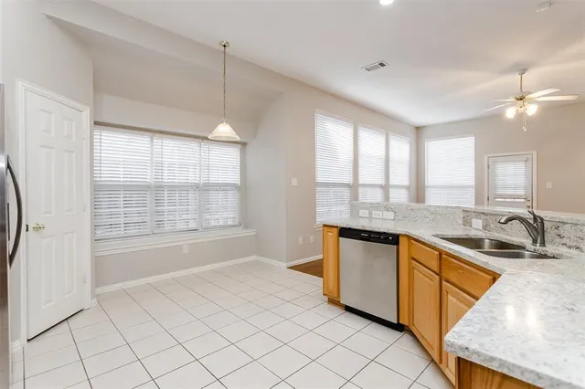 a large kitchen with granite countertop a sink and a stove top oven