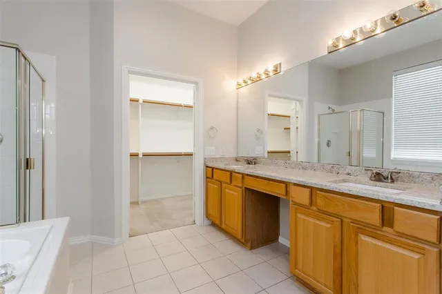 a spacious bathroom with a granite countertop sink and a mirror