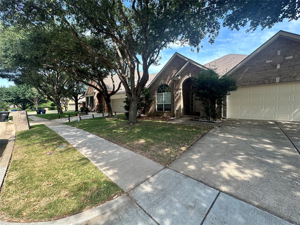 2450 Streamside Court Frisco, TX 75036 - Photo 3 of 28 a view of a white house with a big yard and large tree