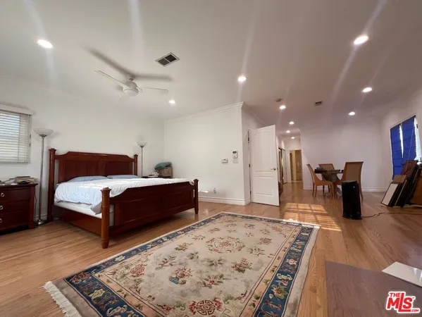 a bed room with a bed and a television