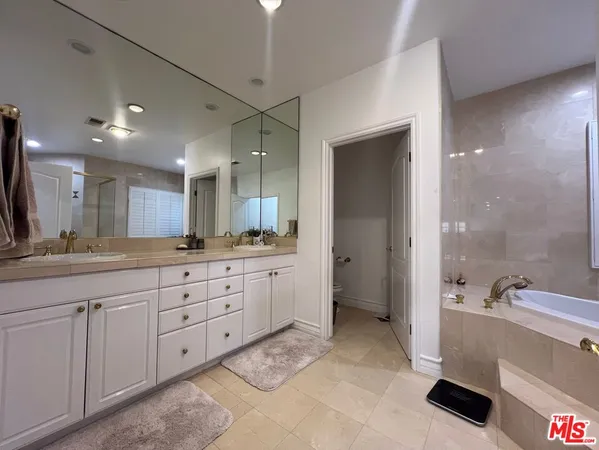 a large bathroom with a granite countertop sink mirror and shower