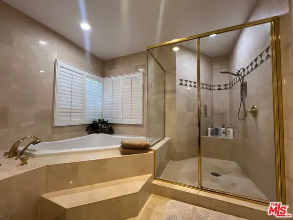 a bathroom with a tub and a shower