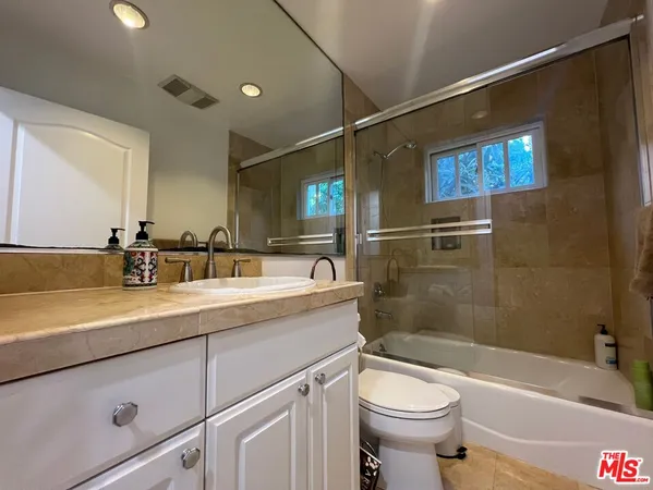 a bathroom with a sink a toilet and a bathtub