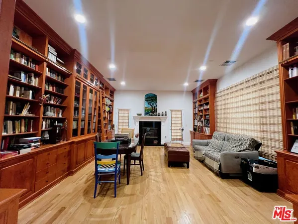 a living room with furniture window and wooden floor