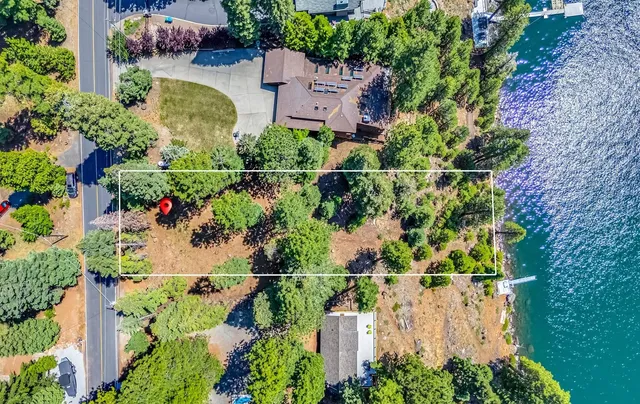 an aerial view of a house with a yard and garden