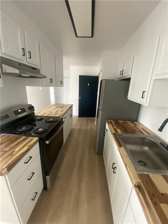 100 2nd Street Braddock, PA 15104 - Photo 15 of 29 a kitchen with granite countertop a stove and a refrigerator