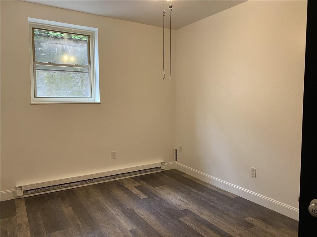 100 2nd Street Braddock, PA 15104 - Photo 21 of 29 a view of an empty room with wooden floor and a window