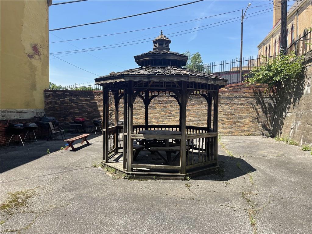 100 2nd Street Braddock, PA 15104 - Photo 7 of 29 a view of roof deck with dining table and chairs with wooden floor