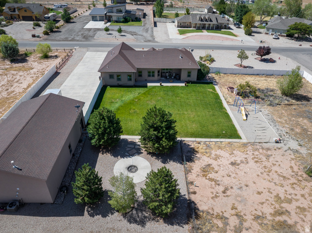 4635 East Sunny Acres Lane Moab, UT 84532 - Photo 3 of 56 Expansive property featuring a detached outbuilding with a private driveway, a manicured lawn, and a dedicated play area