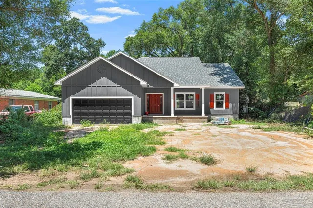 a front view of a house with a garden