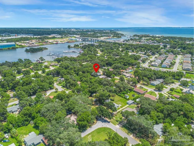 an aerial view of multiple houses with yard