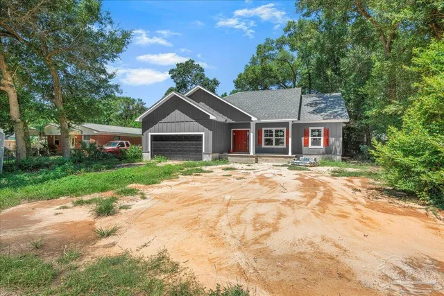 a house with green field in front of it
