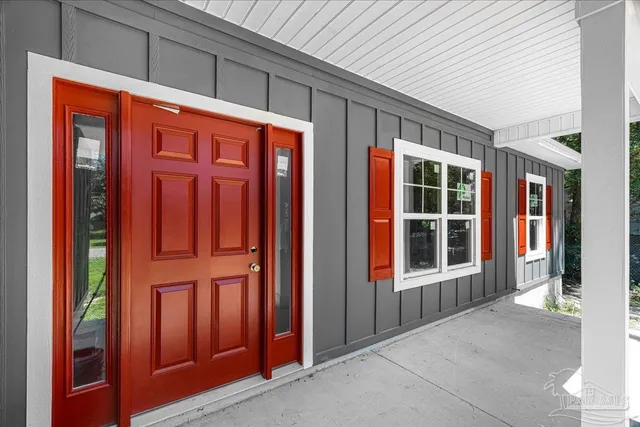 a view of a house with backyard and porch
