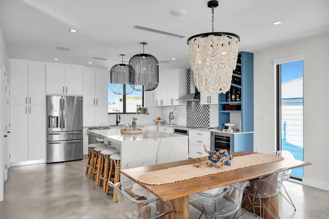 a kitchen with sink and view of living room