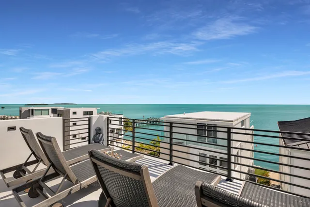 a living room with furniture a flat screen tv and a floor to ceiling window