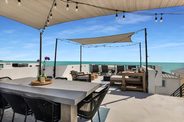 a view of living room with patio furniture and a potted plants