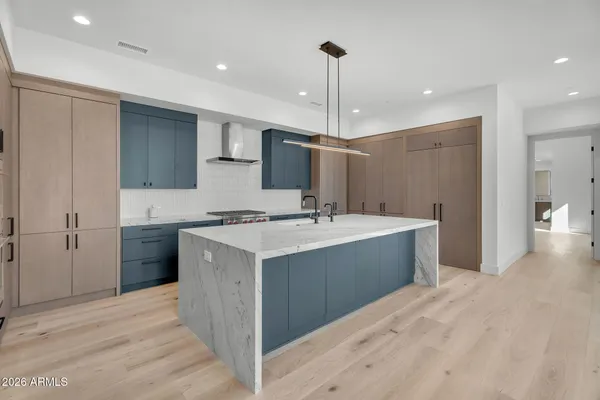 a kitchen with stainless steel appliances a sink and a refrigerator