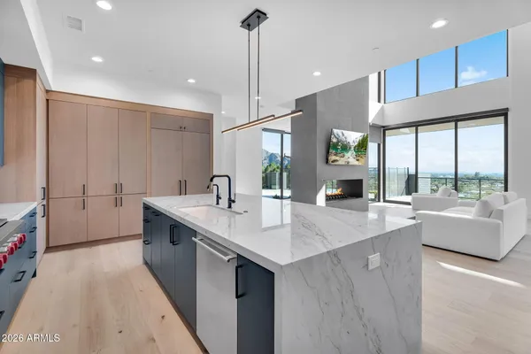 a kitchen with kitchen island a sink appliances and a counter top space