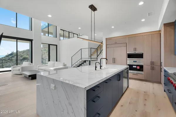a dining room with furniture a floor to ceiling window and a flat screen tv