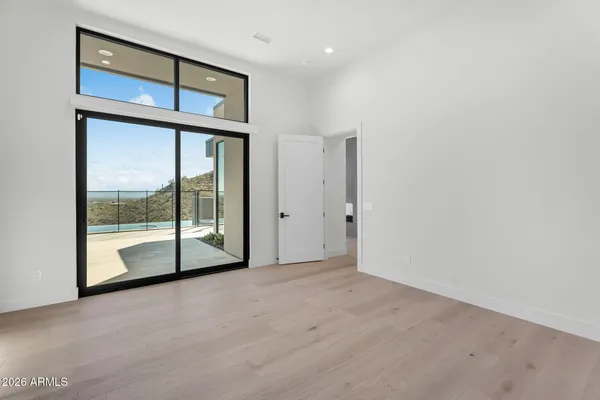 a large bathroom with a double vanity sink a large mirror and a bathtub