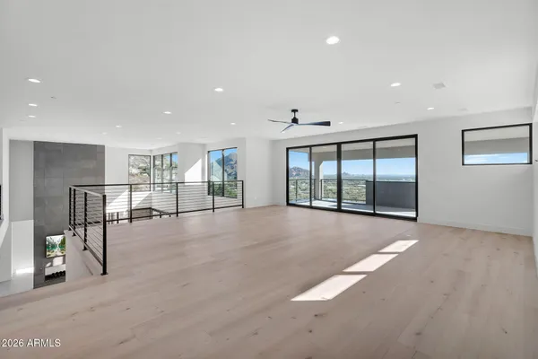 an empty room with wooden floor and doors