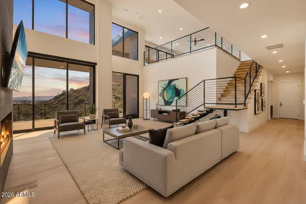a living room with furniture and a floor to ceiling window