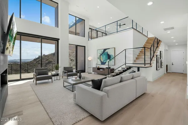 a living room with furniture and wooden floor