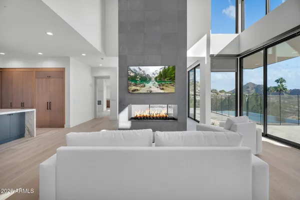 a view of kitchen with stainless steel appliances granite countertop cabinets and wooden floor