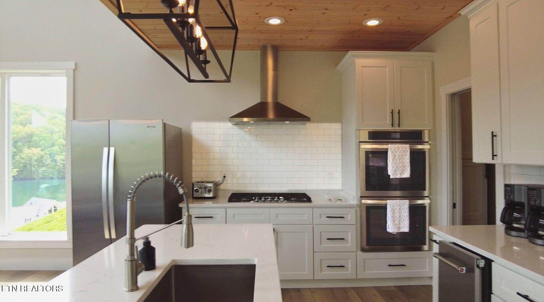 234 Cameron Loop Lane La Follette, TN 37766 - Photo 12 of 60 a kitchen with stainless steel appliances granite countertop a refrigerator and a stove top oven