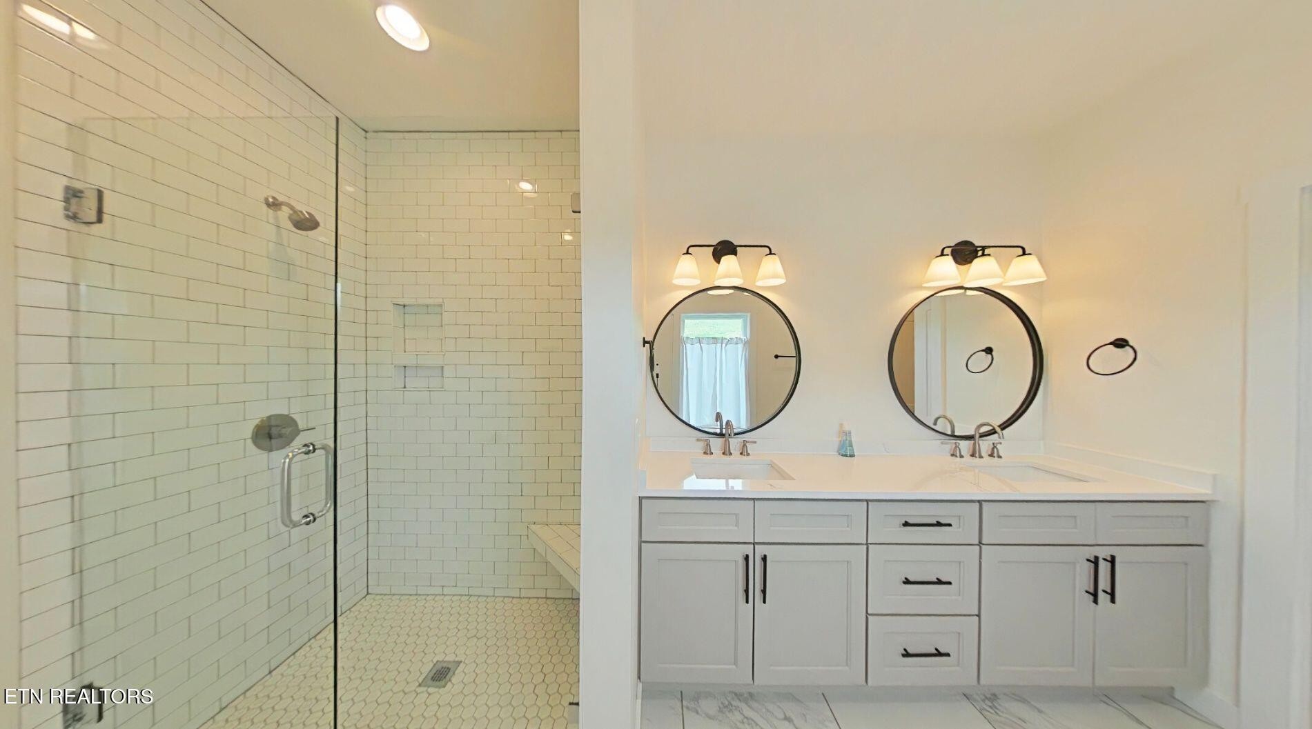 234 Cameron Loop Lane La Follette, TN 37766 - Photo 21 of 60 a bathroom with a double vanity sink mirror and a shower