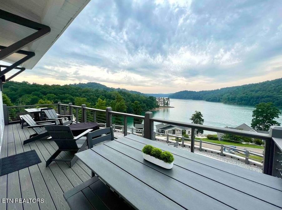 234 Cameron Loop Lane La Follette, TN 37766 - Photo 27 of 60 a view of a roof deck with couches wooden floor and city view