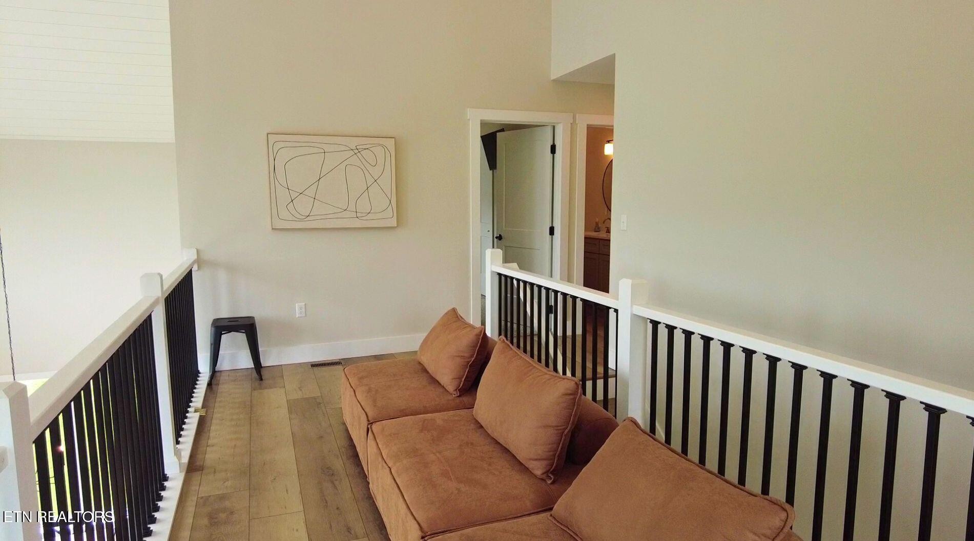 234 Cameron Loop Lane La Follette, TN 37766 - Photo 31 of 60 a balcony with furniture and wooden floor