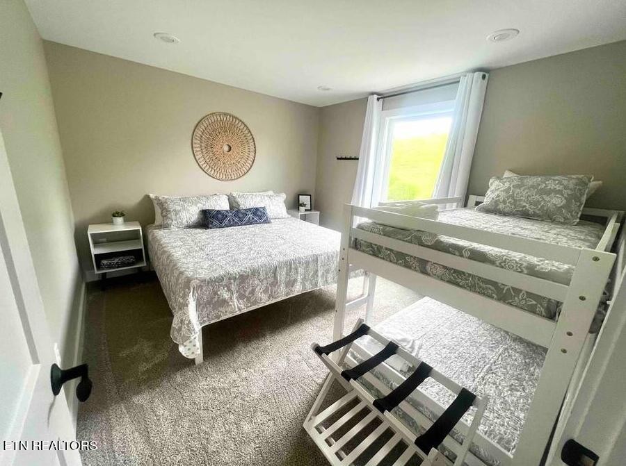 234 Cameron Loop Lane La Follette, TN 37766 - Photo 37 of 60 a bedroom with a bed and a chandelier