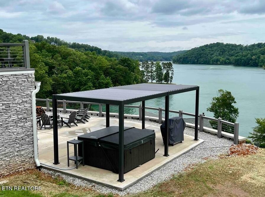 234 Cameron Loop Lane La Follette, TN 37766 - Photo 42 of 60 a view of a roof deck with table and chairs under an umbrella