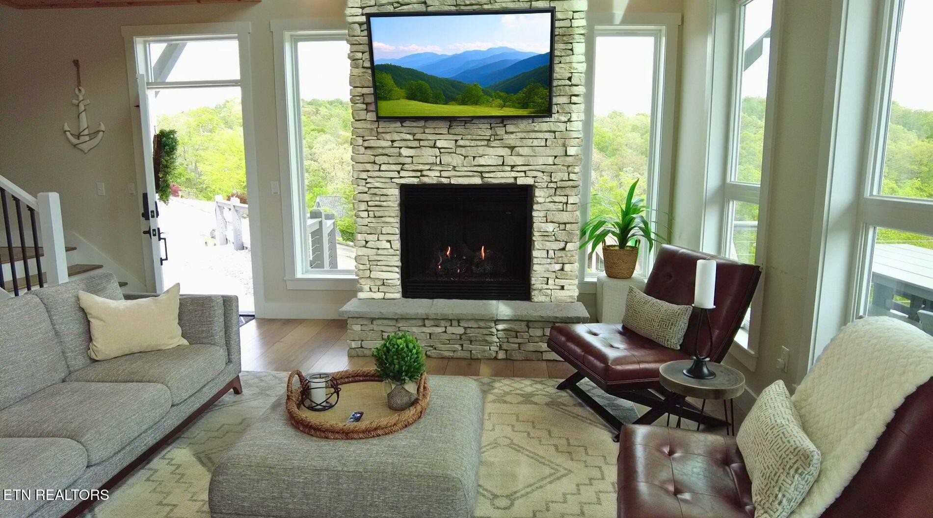 234 Cameron Loop Lane La Follette, TN 37766 - Photo 9 of 60 a living room with furniture and a fireplace