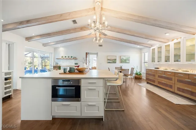 a living room with furniture a lamp and a potted plant